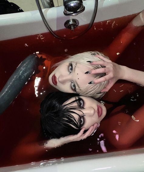 Two girls seated in a bathtub. Birds eye view. Blood-red water. 

@zaperwave on Instagram
@runabyte on Instagram
Goth blood aesthetic bathtub lesbian scene emo dark horror Gothic whimsigoth bloodbath bloody pretty beautiful grunge blonde brunette dark eyes hot red white black eyeliner makeup lipstick dramatic photography nails manicure Demon demonic devil succubus evil horror Two People, Hairstyles, Red