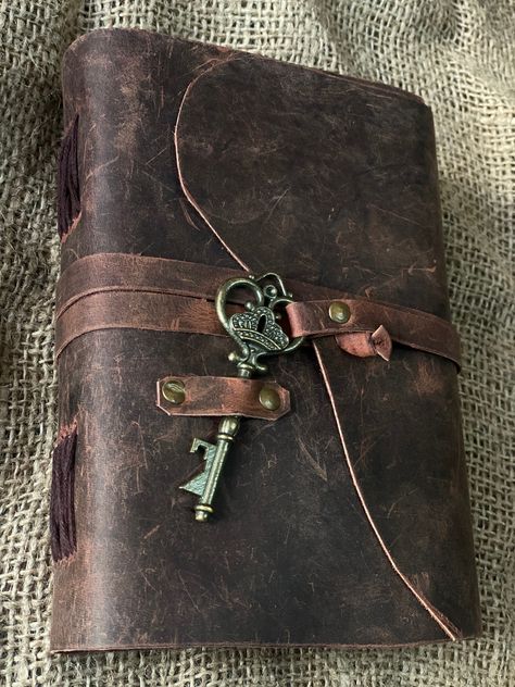 "Beautiful Cow Hide Leather Journals Soft and Durable Dark Brown Genuine Leather Bound With Key,  - No glue used. - Hand Stitched. - Binding diary (paper is not refillable). - Real Leather scent. - Deckle Edge paper - each journal is very special  Size - (length) 7\" x (Hight) 5\" x (width) 2\" inch. A perfect combination of luxurious leather cover and perfect quality paper. OUR DARK BROWN LEATHERBOUND NOTEBOOKS MAKE HEARTWARMING BIRTHDAY, ANNIVERSARY, VALENTINE'S, GRADUATIONS, ENGAGEMENT, WEDDI Leather Book Aesthetic, Vintage Accessories Aesthetic, Brown Journal, Vintage Notebook Aesthetic, Brown Leather Aesthetic, Old Journal, Leather Book, Old Notebook, Vintage Diary Journals