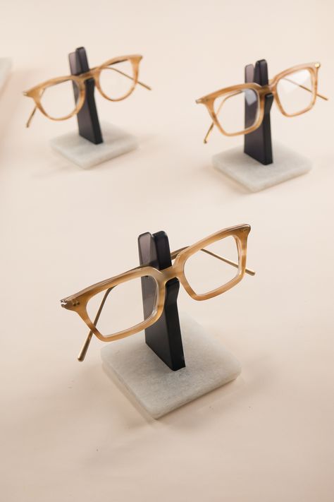 An understated glasses holder to store your spectacles. On your work desk in the office or your bedside table, this minimal Spectacles Holder is the perfect place to hang your eyeglasses. Constructed from recycled plastic bottles, the sturdy base-plate keeps your frame nice and high, away from dust and scratches. This semi-translucent edition is made from a transparent grey upright, with smoothly polished edges and a silky satin finish.