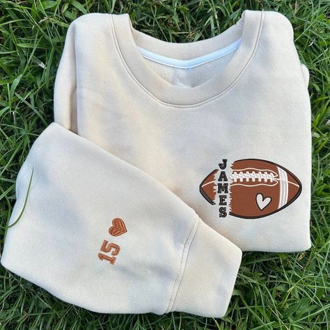 Personalized Football Embroidered Sweatshirt, Game Day Sweatshirt, Custom Football Name And Number On Sleeve Embroidered Sweatshirt Our sweatshirts are 100% embroidered one by one with great care and dedication. They are 100% cotton and double stitched on the sleeves. Great as Birthday gifts or Holiday presents. This adorable item can be designed upon anyone's wish with any title. Maintenance instructions:-Washing and gentle drying under 30 °.-Iron at low temperature inside out or between two sh Football Sweater Ideas, Football Hoodie Ideas, Gifts For Football Players, Football Crewneck, Football Girlfriend, Football Names, Game Day Sweatshirt, Football Shirt Designs, Embroidered Material