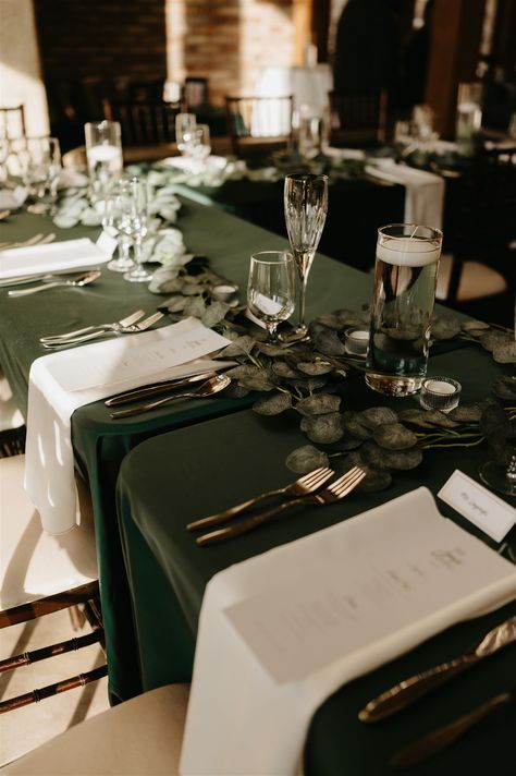 Layne and Francis celebrated a gorgeous winter wedding, which featured hunter green and ivory linens with gold accents ✨ Hunter Green Linens Wedding, Midnight Blue And Emerald Green Wedding, Green Ivory And Gold Winter Wedding, Hunter Green Table Cloth Wedding, Dark Green Table Cloth Wedding, Dark Green Wedding Table Settings, Emerald Green Wedding Decorations Centerpieces Table Settings, Wedding Green Tablecloth, Black And Gold Wedding Tables