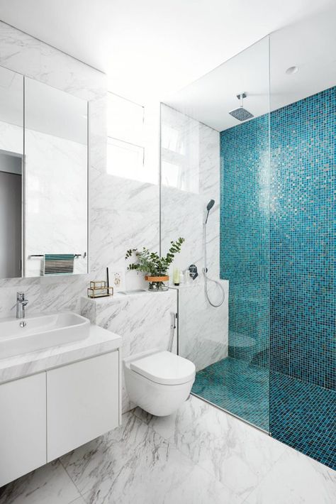 Example of a trendy blue tile, white tile and mosaic tile marble floor walk in shower design in Singapore with flat panel cabinets, white cabinets, a wall mount toilet and a vessel sink Design Interior Baie, Projek Menjahit, Compact Bathroom, Washroom Design, Small Bathroom Makeover, Decor Baie, Blue Tile, Bathroom Tile Designs, Bathroom Design Decor