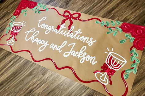 Such a simple and elegant banner design!! I love! ❤️🥂🫶🏼 #banner #banners #bannerdesign #brownpaperbanner #painting #shopsmall #smallbusiness #roses #red #drinks Holiday Banner Design, Brown Paper Banner Christmas, Butcher Paper Banner Christmas, Parade Banner Ideas, Hand Painted Banner Ideas, Christmas Banner Painted, Painted Christmas Banner, Christmas Painted Banner, Friendsmas Banner