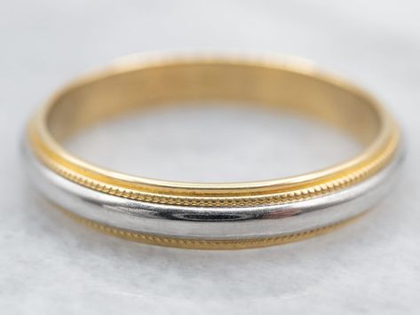 "This shining vintage band is crafted from the highest quality materials: hefty 18 karat yellow gold and platinum that is perfectly polished and shines with light! Weighty on the finger, comfortable and substantial, this two-tone, mixed metals piece is sized for a gentleman with a larger hand but can be easily sized down, just contact us for more information! Metal: 18K Yellow Gold, Platinum Width of Band: 3.9 mm Height off Finger: 1.9 mm Ring Size: 11 Marks: \"18KL & PLAT\" Stamped on the inside band To view a video of this piece check out the link below: https://vimeo.com/825994034 SKU #: A24192 Each piece has been identified and graded by a Graduate Gemologist who has been certified by the Gemological Institute of America (GIA). We have four brick and mortar storefronts in Maine, Massac Mixed Metals Wedding, Mixed Metal Engagement Rings, Two Tone Wedding Band, Milgrain Wedding Band, Mixed Metal Rings, Plain Wedding Band, Gold Diamond Wedding Band, White Gold Sapphire, Stacking Bands