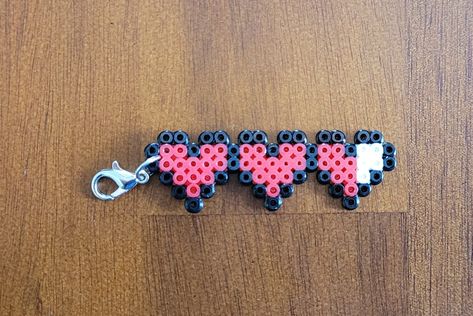 "Life Hearts Mini Perler Beads Keychain/Pendant Just to be clear this item is made from Mini Beads, not regular beads. It has a lobster claw connected to attach to a keychain, necklace, backpack, etc. Size is 5\" x 2\" Great gift idea and stocking stuffer! This item comes with tracked shipping. This item is made by placing bead by bead, or pixel by pixel on a pegboard. The beads are then melted together by ironing one side together to create the finished product. Not seeing the design you like? Perler Bead Phone Charms, Things To Make Out Of Iron Beads, Cheer Perler Beads, Peeler Bead Small Ideas, Minecraft Iron Beads, Perler Beads Small Cute, Perler Bead Matching, Mini Fuse Beads, Mini Perler Patterns