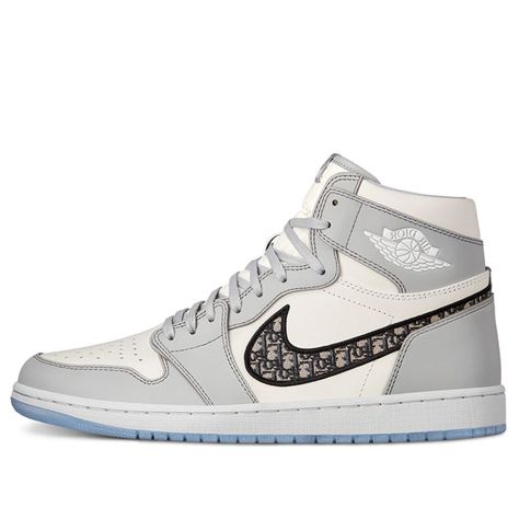 Dubbed “the most luxurious Air Jordan 1 ever”, all 8500 pairs of available Air Diors were made entirely in Italy with the finest materials and craftsmanship. The upper is constructed with white and Dior grey leather, where oblique monogrammed Swooshes enhances the opulent look. Underfoot, an translucent icy outsole completes the design.\n Womens Nike Trainers, White Basketball, White Basketball Shoes, Jordan 1 High Og, Nike Air Jordan 1, Air Jordan 1 High, Jordan 1 High, Sneakers Men Fashion, Dream Shoes