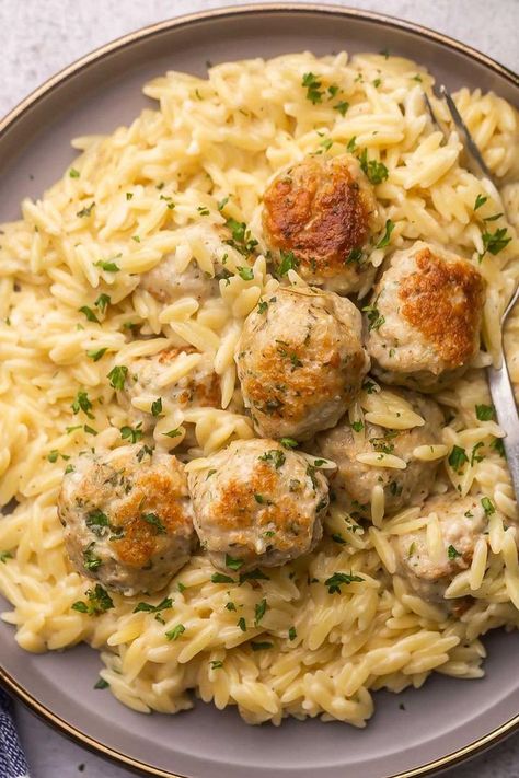 "An enticing image featuring Chicken Meatballs served on a bed of creamy Garlic Parmesan Orzo, a flavorful and comforting dish." Chicken Meatballs And Risotto, Essen, Chicken Meatballs And Gnocchi, Swedish Meatball Orzo, Chicken Meatball Gnocchi, Instant Pot Chicken Meatballs, What To Make With Chicken Meatballs, Garlic Parmesan Chicken Meatballs, Easy Dinner Recipes Meatballs