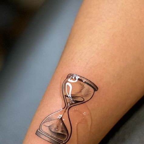 R’ink Tattooz - Tattoo studio, Delhi on Instagram: "Passage of Time: At its core, an hourglass symbolizes the relentless and impartial march of time. The grains of sand slipping from one bulb to another remind us of the fleeting nature of life, urging us to make the most of each precious moment. Hour glass tattoo . For tattoo appointment / queries  📩 @rinktattooz  ☎️ +91 96670 20423 📍 E-13, 2nd floor, South extension II main market, New Delhi  . . #hourglasstattoo #passageoftimetattoo #mortalitytattoo #balancetattoo #patiencetattoo #reflectiontattoo #remembrancetattoo #timetattoo #lifetimetattoo #transformation #steadfasttattoo #philoshopicaltattoo #depttattoo #tattoo #lifebeautytattoo #lifegoal #explore #art #design #ink #tattoodesign #smalltattoo #finelinetattoo #neatlinetattoo #easthe Time Is Priceless Tattoo, Sand Dial Tattoo, Your Time Is Limited Tattoo, Hourglass Tattoo Simple, Time Is Precious Tattoo, Alarm Clock Tattoo, Sand Clock Tattoo, Timer Tattoo, Relentless Tattoo