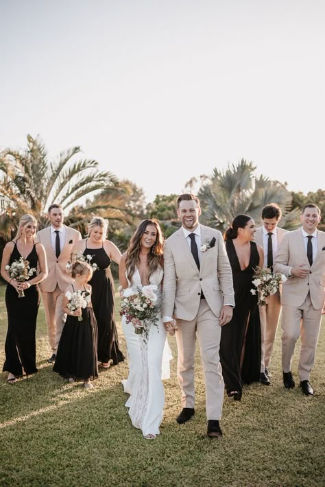 Captured at the stunning Baja Luna, this wedding exudes elegance and joy. The bridesmaids' black dresses and the groomsmen's beige suits complement the natural backdrop beautifully. The lush greenery and tropical palm trees add a touch of paradise to this unforgettable day. #BajaLunaWedding #DestinationWedding #WeddingParty #ElegantWedding #OutdoorWedding #WeddingPhotography #BridalBouquet #TropicalWedding