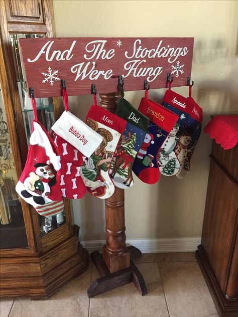 DIY Christmas Stocking Stand from an old porch column and scrap barn wood Christmas Stocking Stand Wooden, Stocking Hanger Stand, Stocking Hangers Diy Wood, Blanket Ladder Stocking Holder Diy, Stocking Post Holder, Stocking Stand Ideas, Stocking Post Diy, Diy Stocking Stand, Homemade Stocking Holders