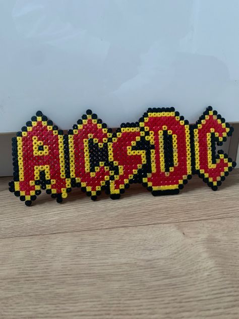 Logo from the band called ACDC iron on beads ideas Perler Bead Band Logos, Rock Perler Beads, Band Perler Beads, Iron On Beads Ideas, Peeler Beads Patterns Easy, Perleplader Ideas, Hama Minecraft, Ironing Beads, Hamma Beads Ideas