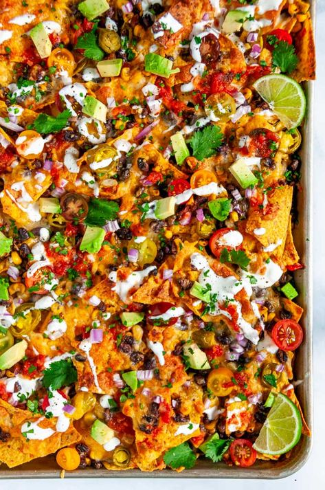 Loaded Vegetarian Sheet Pan Nachos - No superbowl sunday is complete without these crowd pleasing nachos that are done in just 20 minutes . From aberdeenskitchen.com #loaded #vegetarian #sheetpan #nachos #blackbean #corn #mexican #snack #appetizer #recipe #gameday #tailgate Steak Sheet Pan, Vegetarian Sheet Pan, Vegetarian Nachos Recipe, Loaded Nachos Recipe, Sheet Pan Steak, Veggie Nachos, Steak Nachos, Sheet Pan Nachos, Pan Nachos