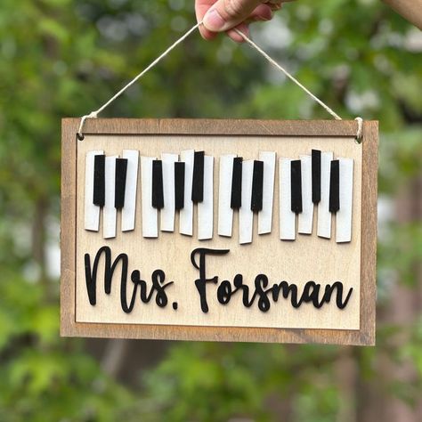 Thank you for checking out my music teacher door hanger listing. This custom music teacher classroom decor sign is not too big and not too small. It is 10 inches wide by 7 inches tall. Personalize your music teacher name sign with your name or gift one of these signs to your music teacher. This sign would make the perfect teacher appreciation gift for your music teacher or piano teacher. Use the sign as a door hanger, wall art, hang it in your music office, etc. Each sign is laser cut from Choir Teacher Gifts Diy, Chorus Teacher Gifts, Music Themed Classroom Door, Music Teacher Door Hanger, Gifts For Piano Teacher, Gift Ideas For Music Teachers, Music Teacher Gifts Diy, Gift For Music Teacher, Music Teacher Gift Ideas