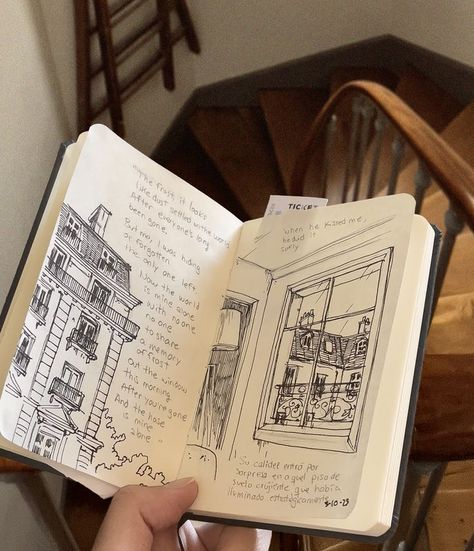 Hand holding open sketchbook with fine line black ink drawings of Paris buildings and roofs and poetic excerpts from Mitski's music. The background features a charming wooden stairway in Paris. Sketch Inspo Aesthetic, Paris Aesthetic Drawing, Fine Line Sketches, Music Sketches Creative, Artists Notebook, Music Sketchbook, Drawing Aesthetic Sketchbook, Architecture Line Art, Sketchbook Art Journal Sketches