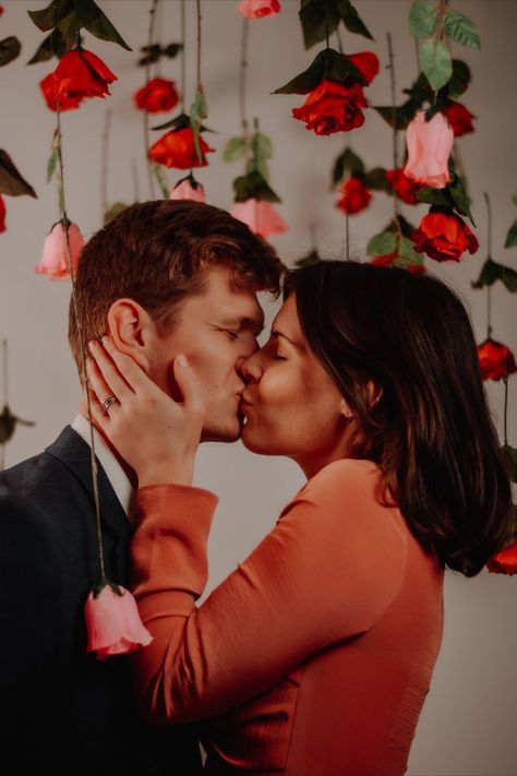 Roses hanging from the ceiling while couple kisses on Valentine's Day Valentines Engagement Photos, Valentines Photography Couples, Valentines Day Photoshoot, Valentine Mini Session, Valentine Photo Shoot, Photography Mini Sessions, Valentines Day Pictures, Studio Portrait Photography, Flower Photoshoot