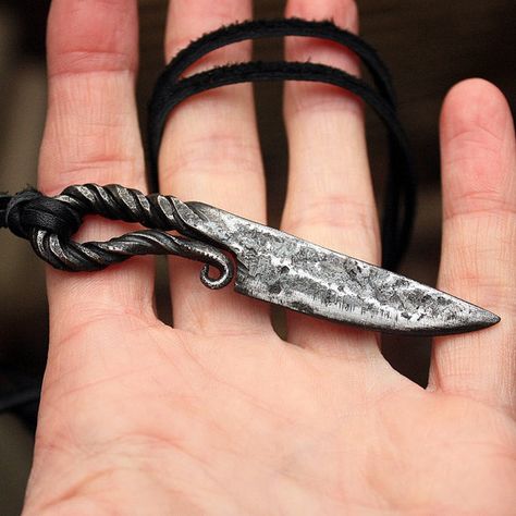 This is a forged iron handmade Viking style knife pendant. The pendant is a mini replica of a Nordic hunting knife tool which ancient Vikings carried with them. It can make a great part of a Larp reenactment costume. The pendant is decorative and not sharp which means it cannot be used to cut.  The knife length is about 2.57-2.65 inches or 60-70 mm. Pendant comes on a black leather necklace and is coated by a water resistant finish to protect from rusting.  ::::::::::PLEASE NOTE:::::::::: Thi... Forged Necklace, Blacksmith Knife, Knife Pendant, Masculine Jewelry, Iron Jewelry, Black Leather Necklace, Iron Pendant, Viking Pendant, Ancient Vikings