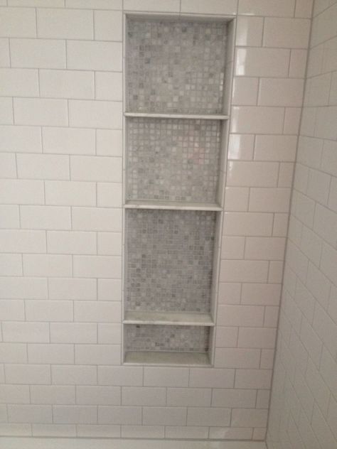 White subway tile in shower with shelf cut-out with smaller penny tile matching floor time color. Only three shelves needed. Subway Tile Shower Designs, Tile Shelves, Subway Bathroom, Tile Tub Surround, Beadboard Bathroom, Bathroom Niche, Subway Tile Showers, Shower Shelf, Tub Surround