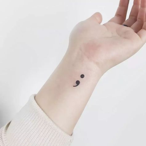 Explore the profound meaning behind a semicolon tattoo—a symbol of hope, resilience, and the continuation of life. 💪 #SemicolonTattoo #TattooArt Embalming Tattoo, Simple Semicolon Tattoo, Snall Tattoos, Mental Health Symbol, Hope Tattoos, Tats With Meaning, Semi Colon Tattoo, Semicolon Tattoo Meaning, Symbol Tattoos With Meaning