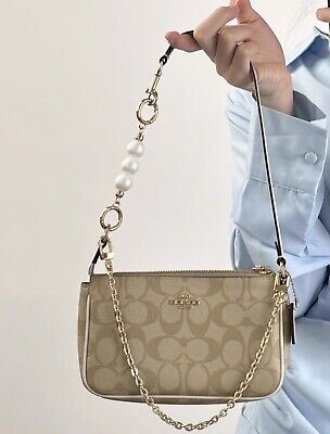 Find ideas๏ฟฝand inspiration for NWT Coach Nolita 19 In Signature Canvas c3308 + Pearl Chain + Wallet CQ145, Bags Coach Bags With Charms, Coach Nolita 19 Outfit, Cute Coach Bags, Coach Purse Aesthetic, Coach Bags Aesthetic, Coach Bags Handbags, Tenis Coach, Coach Bag Outfit, Dream Purse