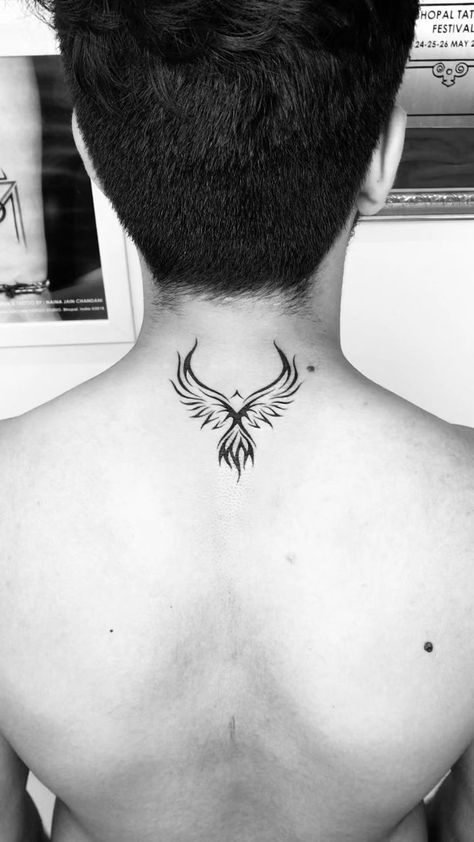 If you're looking for a unique and memorable way to show your support for your favorite team, a back tattoo is the perfect way to do it. From sports logos to traditional images of birds and flowers, there's a back tattoo design that's perfect for you. Back Of Neck Tattoo Men, Phoenix Tattoo Men, Arm Women, Tato Phoenix, Phoenix Tattoo For Men, Small Phoenix Tattoos, Bts Tattoo, Phoenix Bird Tattoos, Best Neck Tattoos