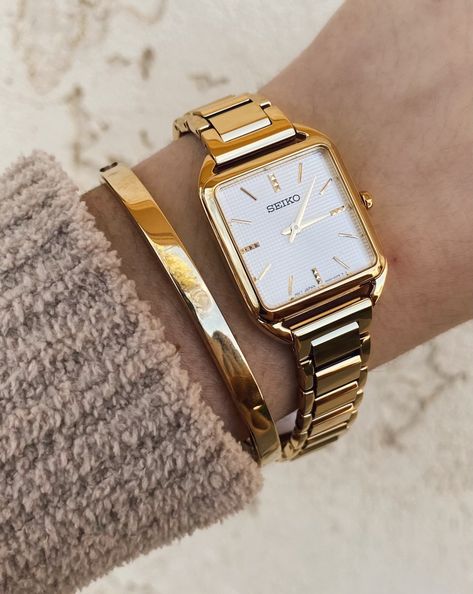 The perfect accessory to dress up any look. From the essentials collection, the Seiko SWR078 features a luxurious stainless-steel square case with an elegant gold finish. #HollandsJewelry #finejewelry #wheretraditionsbegin #traditionssince1918 #shoplocal #familyowned #Seikowatch #Seiko #SeikoStyle Square Face Gold Watch, Gold Square Watches Women, Seiko Essentials Watch, Seiko Watches Women Gold, Dress Watch Women, Seiko Women Watch, Women Watches Classy Elegant, Square Watch Women, Seiko Gold Watch