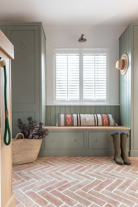 The boot room is a joy of simple function and pared back design, featuring the the gorgeous warm terracotta brick slips flooring which adds a rustic warmth while complementing the natural textures wonderfully and cupboards in a dark grey-green. It has plenty of storage for footwear and coats as well as a bench to sit on with drawers beneath for gloves, hats and scarves. Stone Floor Laundry Room, Mediterranean Style Bathroom, Indoor Tiles, Complete House Renovation, Hallway Tiles, Terracotta Floor Tiles, Orange Tiles, Terracotta Floor, Brown Shade