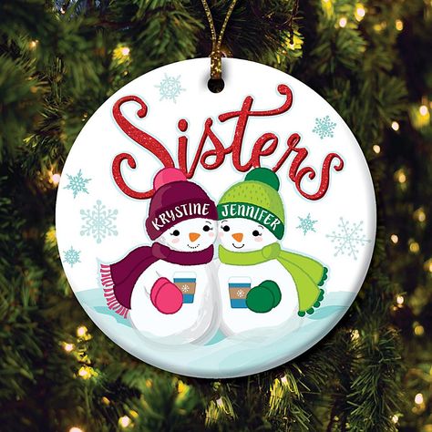 Two Snowmen Sisters Personalized Ceramic Ornament Add a touch of sisterly love to your Christmas tree with this customizable snowman sister ornament. Adorably sweet, this unique design is sure to light up your tree for years to come. Stars two sisters you can personalize with names on the brims of their winter hats. Create a delightful addition to your holiday celebrations, or a fabulous gift for beloved sister, when you personalize this outstanding ornament.  What You Get      Ornament     Gold string for hanging Painted Round Wood Christmas Ornaments, Gnome Plates, Sister Christmas Ornaments, Sister Ornament, Man Glasses, Friendship Ornaments, Circle Crafts, Pot Painting, Snowman Design