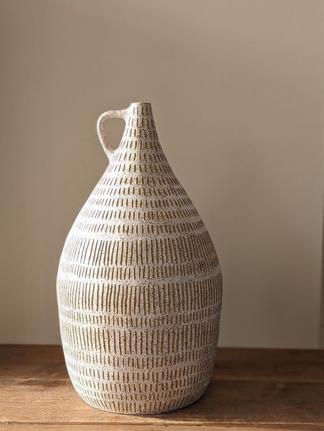 This handmade vase has been lovingly built using coils from a beautiful speckled stoneware clay. Inspired by natural forms from nature it is decorated with a soft white slip and then carved freehand using sgrafitto technique to produce the patterns. This is a beautiful statement piece for your home. This vase is approximately 38cm H. Ceramic Pottery Vase Ideas, Ceramic Vase Handmade, Pottery Decorating Techniques, Handbuilt Ceramic Vases, Pottery Vessels Ideas, Sgrafitto Ceramics Patterns, Pottery Coil Ideas, Coil Built Pottery, Slip Decorated Pottery