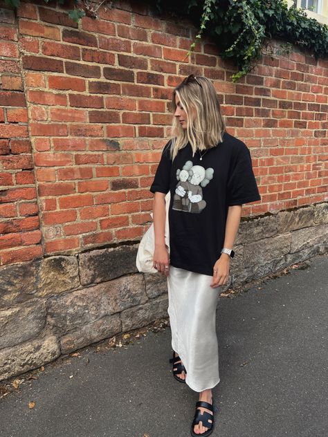 Maxi Skirt Outfit Tshirt, Uniqlo Kaws Outfit, Black Skirt Tshirt Outfit, Satin Skirt Tshirt Outfit, Maxi Skirt Oversized Shirt, Midi Skirt And Tshirt, Cream Maxi Skirt Outfit, Oversized Tshirt With Skirt, Long Skirt Tshirt Outfit