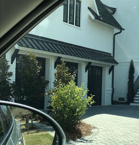 Love the roof overhang. also called "eyebrow roof" for image searches. Daniel Island Metal Roof Over Garage Door, Exterior Overhang Ideas, Garage Door Overhang Metal, Decorative Garage Overhang, Eyebrow Window Awning, Metal Eyebrow Over Garage, Black Metal Awning Over Garage Door, Small Roof Over Garage Door, Garage Door Eyebrow