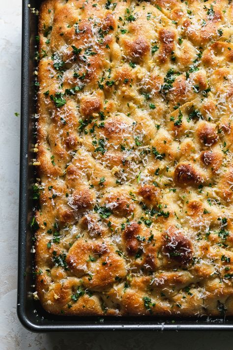 This Garlic Bread Focaccia is fluffy on the inside, crunchy and deeply golden on the edges, and doused in melted garlic butter. It's undoubtedly on of the best things to ever come out of my kitchen. It's the perfect vehicle for sandwiches, served with soup, dipped in more garlic butter (!!), or just simply eaten on its own. Salty, garlicky, buttery, fluffy, crunchy, golden brown perfection! Foccacia Garlic Bread Recipes, Foccacia Bread Bubbly, Garlic Parmesan Foccacia Bread, Foccacia Bread Garlic Butter, Focaccia Garlic Bread, Garlic Bread Foccacia, Friccocia Bread, Garlic Butter And Cheese Stuffed Focaccia, Garlic Butter Focaccia