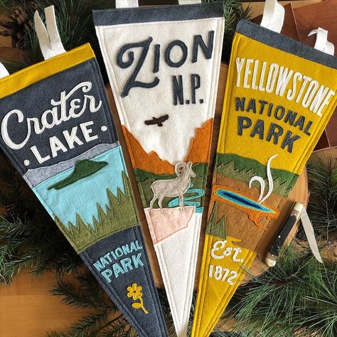 Yoho & Co. Designer Pennants on Instagram: “Designer pennants for all the national parks fans.  100% sewn, made in the Rockies. —— #craterlake #craterlakenationalpark…” Vintage Felt Pennants, Vintage Camp Interior Design, Vintage Camping Bedroom, Pennant Decor Ideas, Pennant Flags Boys Room, Vintage National Park Nursery, Vintage Camping Nursery, Camp Pennant Flags, Outdoor Boys Room