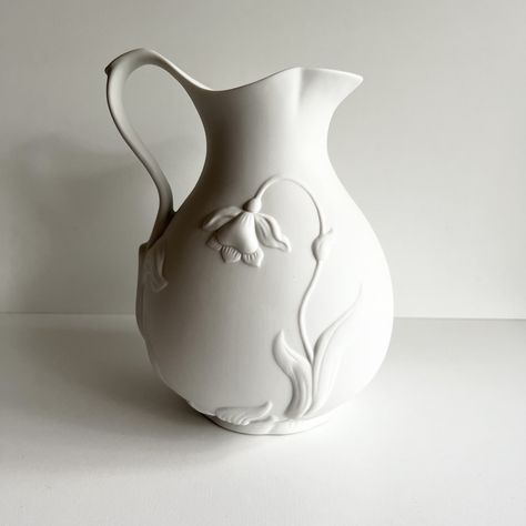 "This pitcher, jug or vase is stunning!  The 3D jonquil and leaf design on this bisque porcelain known as parian porcelain would be a lovely edition to almost any décor.  It is simple yet makes a statement.  So lovely as part of a white on white décor theme.  DIMENSIONS: 7\" wide x 9\"  tall   CONDITION: Excellent, no chips or cracks For more vases click here: https://etsy.me/3xPHpNm Return to the Vintagerous glass home page here: http://www.etsy.com/shop/Vintagerous ID#: 24-4-680-24-404-A-22" Ceramic Vase Texture, Large Wheel Thrown Pottery, Jug Design, Porcelain Handmade, Pottery Items, Pitcher Pottery, Tiny Vases, Minimal Pottery, Clay Vases