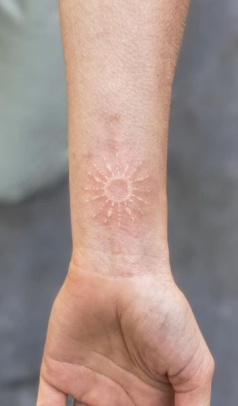 Faded White Tattoo, Stick And Poke Tattoo White Ink, Hand Tattoos White Ink, White Ink Sun Tattoo, White Ink Wrist Tattoo, White Wrist Tattoos For Women, White And Black Ink Tattoo, White Tattoos On Pale Skin, Tiny White Tattoos