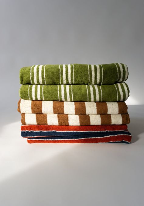 Pool Towels from Autumn Sonata. A plush, generously-proportioned organic cotton towel constructed in a double-sided jacquard weave. The towels are oversized and extremely absorbent–perfect for use as a beach mat, or to simply dry off. Helena: Tile, Navy & Ecru - A bold and alluring stripe reminiscent of 1920s beach umbrellas. The evocative pattern features navy and tile stripes interspersed with ecru lines to balance, providing a beautiful graphic backdrop to beach days. Charlotte: Olive & Ecru 1920s Beach, Navy Tile, Autumn Sonata, Tv Nook, Breton Stripes, Pool Towel, Striped Towels, Towel Pattern, Beach Umbrella