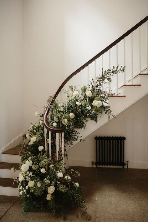 Stairs decorated with green and white wedding flowers. Aswarby Rectory wedding venue, Lincoln. Photography by Lincoln Pictures. Wedding Flowers On Stairs, Flowers Down Stairs Wedding, Stair Florals Wedding, Wedding Stairs Flowers, Flowers On Stairs Wedding, Green And White Wedding Flowers Decor, Stair Flowers Wedding, Stairs Decor Wedding, Aswarby Rectory Wedding