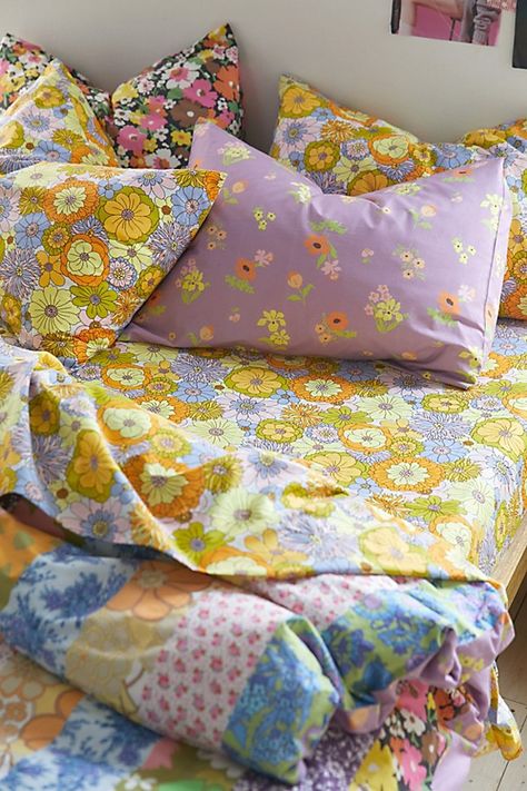 Infuse your space with vibrant pops of color when you wrap up in this patterned sheet set featuring multi-colored retro florals printed allover. Made from a seriously soft cotton-polyester blend that lends a refreshing feel to your bed. Available in sizes Twin XL, Full, Queen and King, each set includes a flat sheet, fitted sheet and pillowcases. Available exclusively at Urban Outfitters. Features Patterned sheet set from UO Home in the softest cotton-poly blend Finished with vibrant florals pri Bedding Sets Full Size, Things To Add To Your Bedroom, Cool Bedsheets, Vintage Colorful Home Decor, Urban Outfitters Bedroom Aesthetic, Mixed Pattern Bedding, Wildflower Bedding, Calm Room Aesthetic, Bright Boho Bedroom