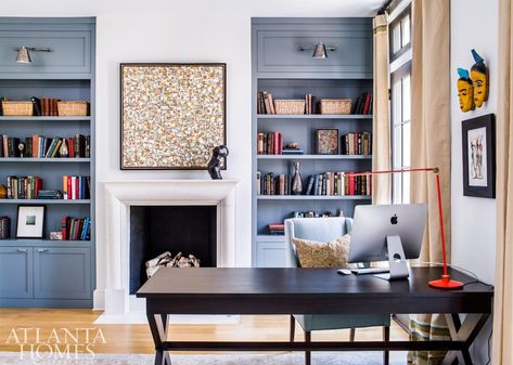 Benjamin Moore’s Templeton Gray makes the built-in bookcases stand out in the library. “It actually takes on a more blue cast with the light in this room,” says McFadden. A contemporary painting and a bronze sculpture bring liveliness to the limestone fireplace. Airy Office, Home Library Bookshelves, Bookshelves Around Fireplace, Blue Bookshelves, Painted Built Ins, Office With Fireplace, Fireplaces Layout, Fireplace Bookshelves, Bookshelf Plans