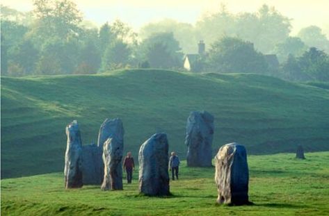 Avebury stones Wiltshire. Avebury in England is home to a 5000 year old neolithic monument. The site, a large henge with several stone circles and avenues, is a spiritual center among pagans and wiccans and is said to stand on the St Michael ley line. Nearly half of England's crop circles are located within 9 miles (15km) of the site. Megalithic Monuments, Stone Circle, Standing Stone, Stone Path, England And Scotland, Sacred Places, Stonehenge, Magical Places, Pilgrimage