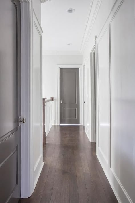 Chic hallway features white walls fitted with gray paneled doors adorned with polished nickel door ... Hallway Colors, Interior Door Paint Colors, Interior Door Colors, Cottage Getaway, Grey Interior Doors, White Hallway, Painted Interior Doors, Greige Design, Door Colors