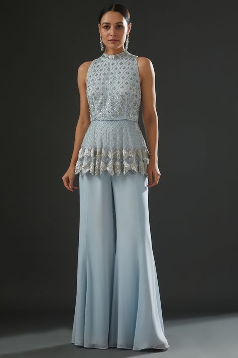 Featuring a powder blue peplum top in georgette and organza base with floral embroidery. It is paired with matching flared pants. . #perniaspopupshop #whatiworewastrending #ppuslove Indian Outfits Modern, Sharara Dress, Blue Peplum Top, Frock Designs, Boot Cut Pants, Bootcut Pants, Indian Fashion Designers, Frock Design, Pernia Pop Up Shop