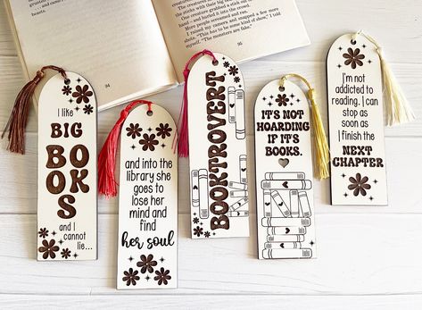 Add a touch of humor to your reading experience with these fun and funny bookmarks. The set includes 5 bookmarks that are laser engraved on beautiful matte white wood. Each bookmark measures 6.5 x 2 inches and comes with a colored tassel that is randomly selected. The unique quotes on each bookmark make them stand out and add a touch of personality to your reading. These bookmarks are perfect for gift giving to your favorite book lover this holiday season. The matte white wood used for the bookm Funny Book Mark Ideas, Bookmark Business, Bookmark Ideas Funny, Book Lover Cricut Ideas, Bookmark Quotes Funny, Bookmark Sayings Quotes, Funny Bookmark Quotes, Book Quotes For Bookmarks, Funny Bookmarks