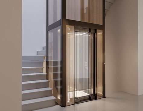 Stairs Lift Design, Elevator And Stair Design, Stairs With Elevator Design, Stairs With Lift, Glass Elevator Design, Glass Elevator Design Interiors, Lift Design Interior, Hotel Lift Lobby, Lobby Residential