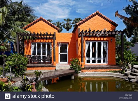 Newly painted bright orange house exterior. Thailand S. E. Asia Stock Photo Orange House Exterior, Paint House Exterior, Hua Hin District, Dog Cottage, Image Orange, Paint House, Salty Dog, Orange House, Orange Paint