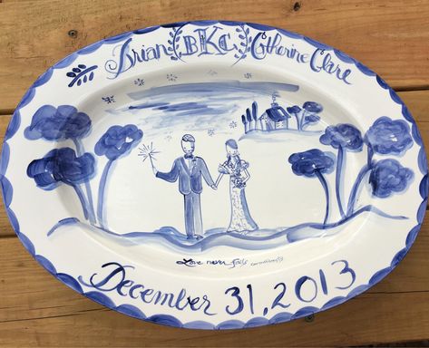 "Made to order custom wedding platter by Tricia Lowenfield Design. 17\" L x 12\" W x 2\" H 2\" Rim Blue and white platter When you have known the bride or groom since they were a child and only something personal will do , this is the perfect gift. Give us the names and date, and feel free to upload a photo of the couple to our Messages portal. We will get started on creating a one-of-a-kind gift! Give us approximately 4-5 weeks to create this especially for you. Handpainted and fired in our kil Wedding Platters, Ceramic Wedding, Blue And White Wedding, Birthday Plate, Plate Hangers, Wedding Plates, Perfect Wedding Gift, Newlywed Gifts, Wedding Portrait