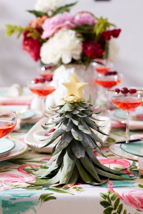 It’s summer, and we love summer! But for a little fun (and to make the sunny season even brighter), why not add a splash of wintry whimsy to your summer wonderland? In celebration of being more than halfway to the holidays, we’re setting the scene with two Christmas in July party themes. Both party themes include a DIY project to try and a “cup of cheer” drink recipe to get you in the spirit of the seasons—summer and winter together. Read on and get your ho-ho-hos while it’s hot-hot-hot! Tropical Christmas Party Decorations, Summer In Winter Party Theme, Tropical Holiday Decor, Christmas Luau Decorations, Christmas Tiki Party, Tropical Holiday Party, Summer Christmas Food Ideas, Hawaiian Christmas Dinner, Christmas In July Bridal Shower Ideas