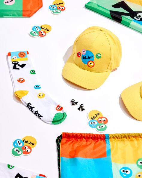 Our client @frasers_property_australia comissioned the cutest merch ever for one of their shopping centres. 🩵💛🧡💚 Ed.Jnr is a brand new kids club at Ed.Square Shopping Centre. The quality product suite features our Wonderpack, Watson Cap, Cheerful socks, Vinyl stickers and Cutie Pins - fully customised with Ed Jnr bright, fun branding. The purpose of this merch is to give out to new kids when they sign up to join the club. Score! Unique Merchandise Ideas, Gen Z Merch, Studio Merch Photography, Fun Merch Ideas, Cool Merchandise Ideas, Stickers Photoshoot, Brand Merchandise Ideas, Merch Socks, Merch Ideas Products