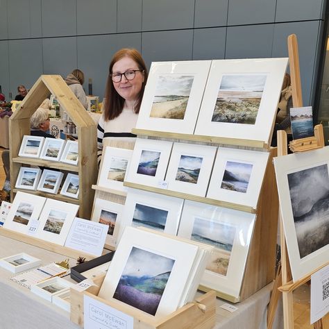 artist standing in front of display of scottish art prints How To Display Canvas Art At Craft Show, Art Market Display Booth Ideas, Print Display Ideas, Art Vendor Booth Ideas, Art Market Booth, Art Show Display Ideas, Art Market Display, Art Exhibition Ideas, Market Displays Booth Ideas