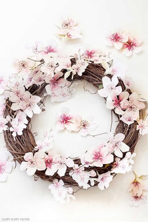 Make this easy and pretty wreath. This easy How to Make a Paper Flower Wreath DIY is perfect for the spring. This wreath uses watercolor cherry blossoms that you cut out and glue to a grapevine wreath. It is a simple wreath that is beautiful and nice year round. The supplies include a wreath, paper, scissors, glue, and ribbon. #crafts #wreaths #spring Unusual Wreaths, Flower Wreath Diy, Cherry Blossom Wreath, Make A Paper Flower, Paper Flower Wreath, Paper Flowers For Kids, Crafts Wreaths, Wreath Paper, Simple Wreath