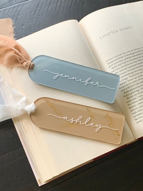 Personalized Bookmark / Custom Name Bookmark / Bookish Gifts / Bookmark Personalized / Bridal Gifts / Booklover Gift / Graduation Gift [ Details ] Handcrafted personalized acrylic bookmark with permanent quality vinyl. Background colors are applied with acrylic matte paint and sealed. Each bookmark includes a ribbon or tassel of your choosing. These are not only great for marking a page in your book, but also great for keeping your page in a planner/journal or even using it as bookshelf decor to display! * Swatches of vinyl color, background color, and ribbon/tassel color is included in the listing photos, please make custom selections where advised * [ Sizing ] Round top bookmarks - 2 x 6 inches and .12 inches thick [ To Note ] All bookmarks are sealed with heat. Bookmarks may break if no Bookmark Bible Verse, Personalized Bridal Gifts, Bible Bookmark, Vinyl Personalized, Custom Bookmarks, Personalized Bookmarks, Kindle Case, Gift Graduation, Bookish Gifts